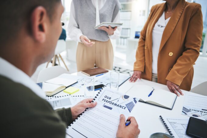 A workplace performance management meeting showing an employer reviewing employee performance records, highlighting the importance of good record keeping under the new Fair Work Commission artificial intelligence requirements.